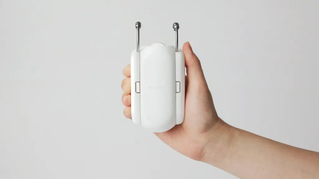 Best Smart Home Devices for Remote Workers in the US (2025 Guide) 6 A person's hand holding Switchbot curtain device
