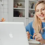 A woman working remotely on a MacBook