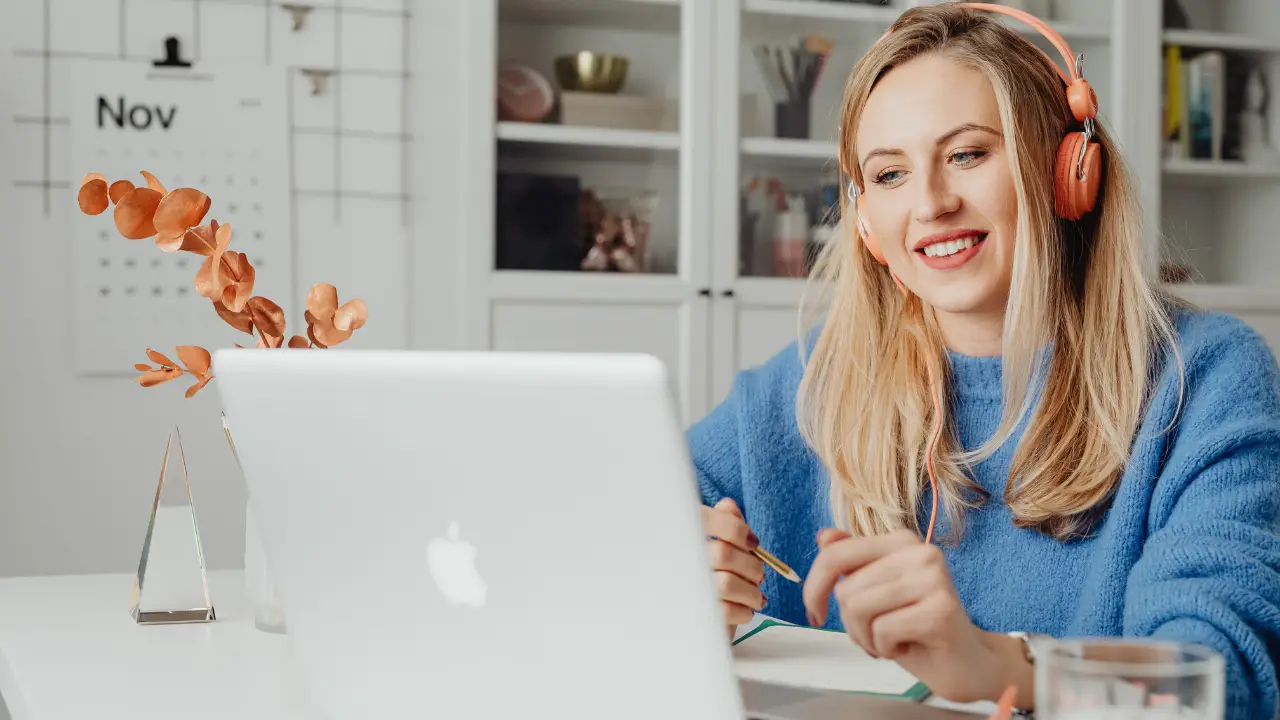 A woman working remotely on a MacBook