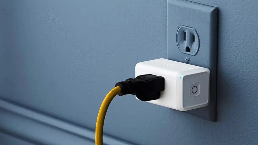 Image of TP Link Kasa Smart plug attached to a wire on a grey wall