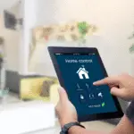 A man holding a Tablet and controlling Home with Smart Home App