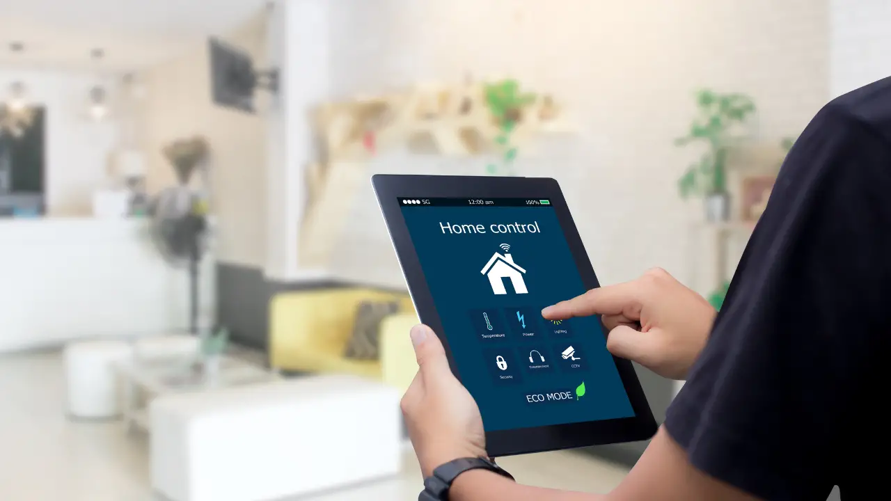 A man holding a Tablet and controlling Home with Smart Home App
